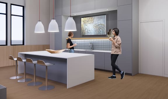 A woman is standing in a modern kitchen with a bar area and a woman is standing at the bar area.