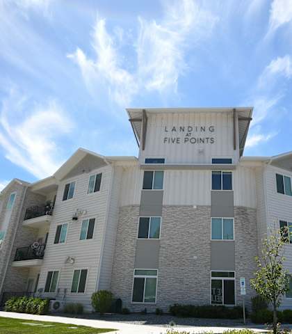 an apartment building with a sign that reads laughing tree farms
