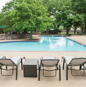 a gym with weights and other equipment in a building with windows at Riverset Apartments, Memphis, 38103