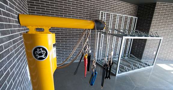 A yellow pole with a bike rack attached to it.