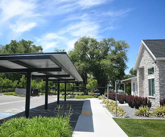 a patio with awnings in front of a house