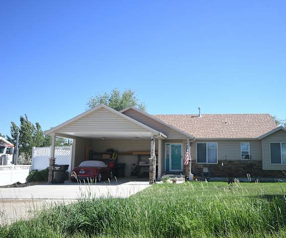 the front of a house with a car in the driveway