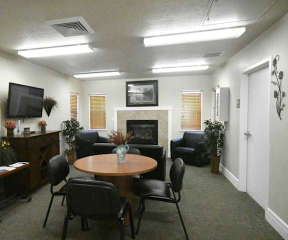 a living room with a table and chairs and a fireplace