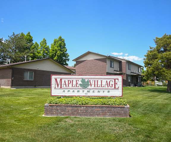 the sign in front of the maple village apartments