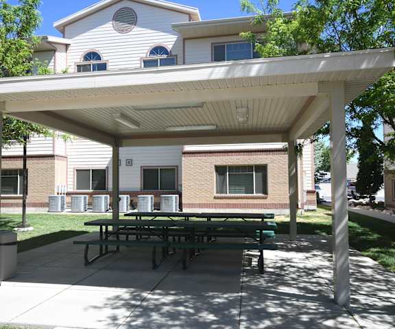 a picnic area with awning in front of a building