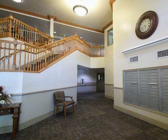 the lobby of a building with lockers and a clock