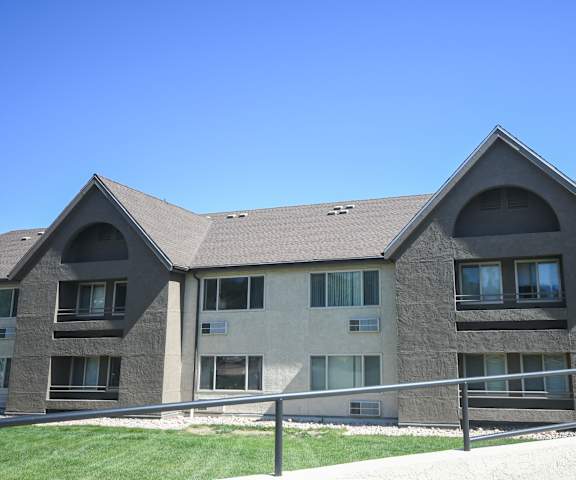 an apartment building with a fence in front of it