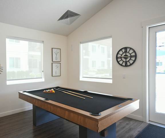 a games room with a pool table and a dart board