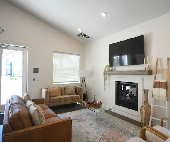a living room with a fireplace and a tv above it