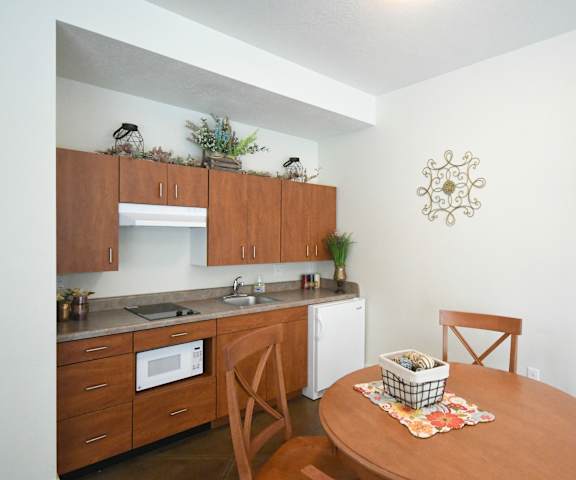 a small kitchen and dining area with a table and chairs