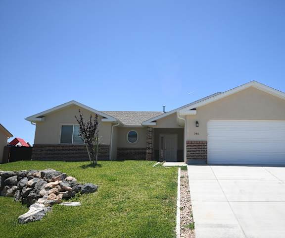 a house with a white garage door and a lawn