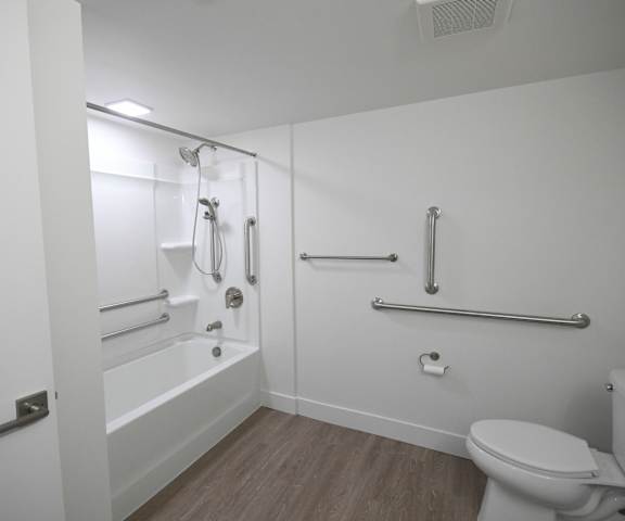 a white bathroom with a toilet and a tub and a sink
