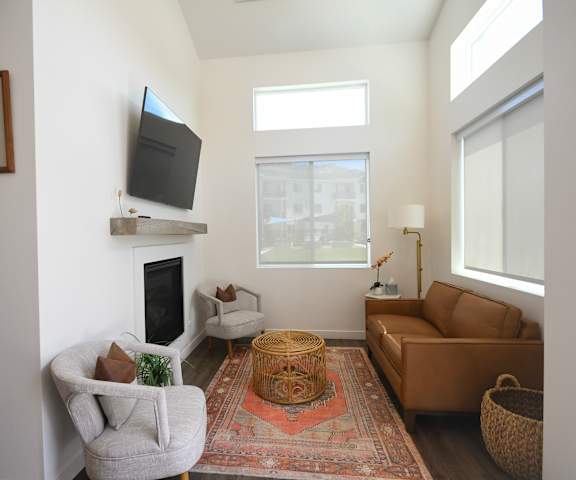 a living room with a couch and a chair and a television