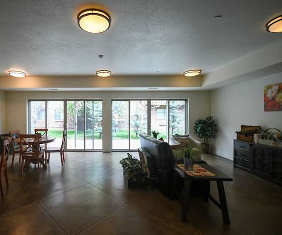 an open living room and dining room with sliding glass doors