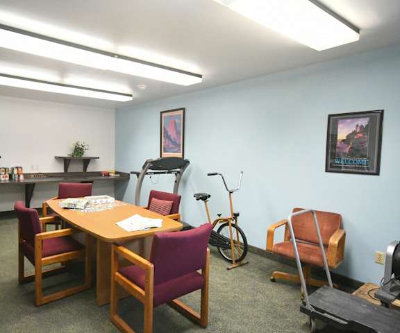 a conference room with a table and chairs and a bike in the corner