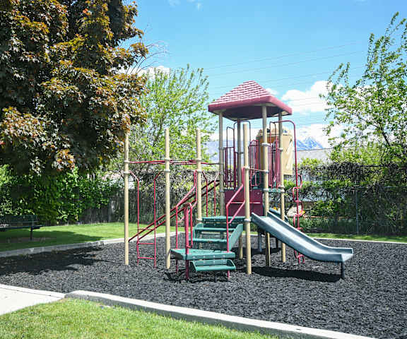 a playground with a slide in a park