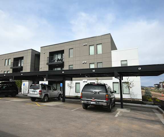 a parking lot with cars parked in front of a building