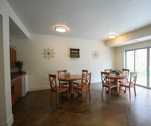 a dining room with a table and chairs and sliding glass doors