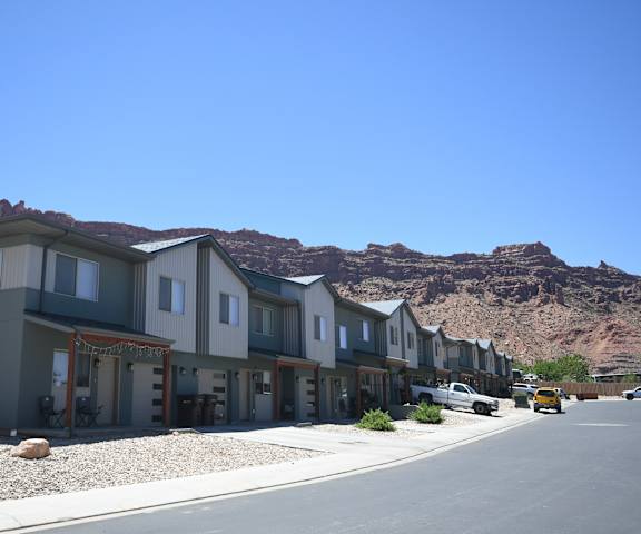 a row of houses with mountains in the background