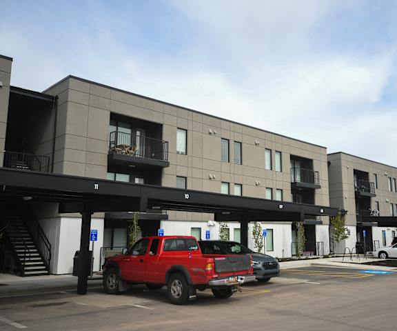a parking lot with cars in front of a building
