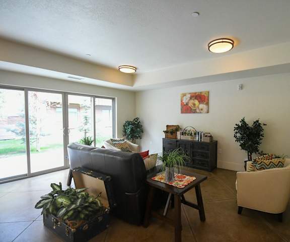 a living room with a couch and chairs and a table