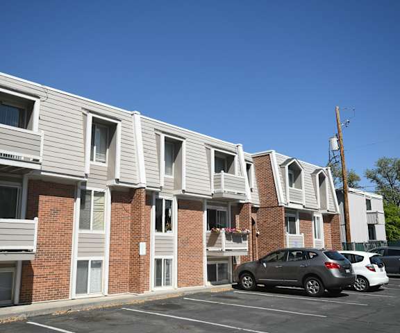 an apartment building with cars parked in front of it