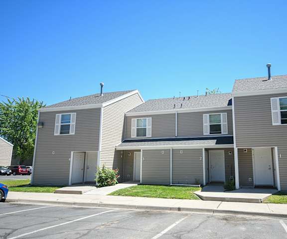 the front of a house with three garages and a lawn