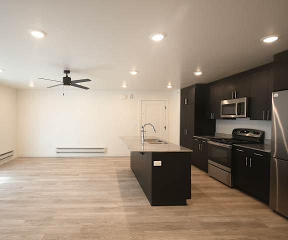 a kitchen and living room in a new home