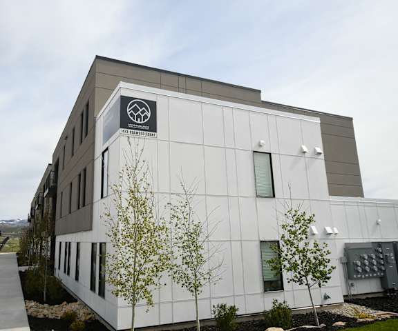 a large white building with a logo on the side of it