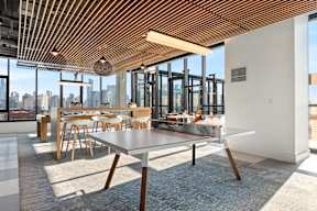 A modern dining area with a long table and chairs.