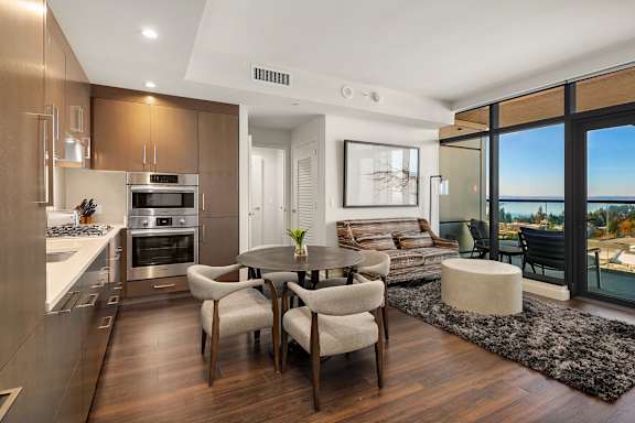 a living room with a kitchen and a table and chairs at Two Lincoln Tower Apartments, Bellevue, WA, 98004