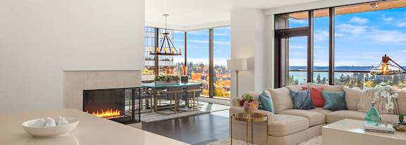 A modern living room with a fireplace and a view of the city. at Two Lincoln Tower Apartments, Bellevue, WA, 98004