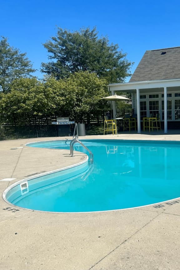 a swimming pool with a house in the background at Traditions at Slate Ridge, Ohio, 43068