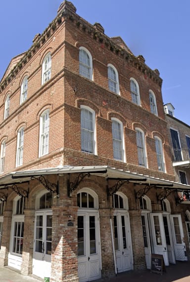 an old brick building on the corner of a city street