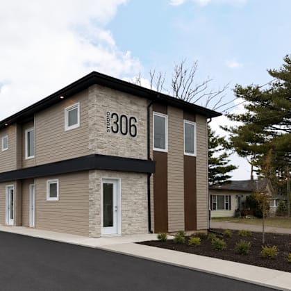 A modern two-story building with the number 306 on the front.
