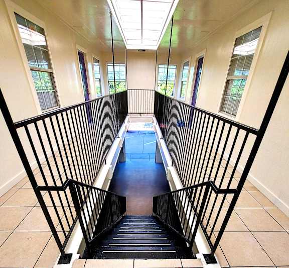 a view down the stairs of a building with windows