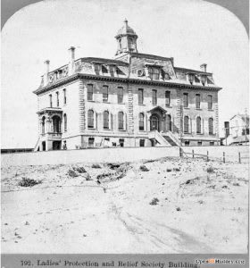 A black and white photo of a large building with a tower and the number 192 on it.