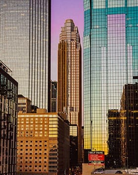 A view of the downtown Minneapolis skyline, featuring a mix of modern high-rise buildings and historic architecture.