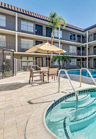 A swimming pool in a courtyard surrounded by apartment buildings.