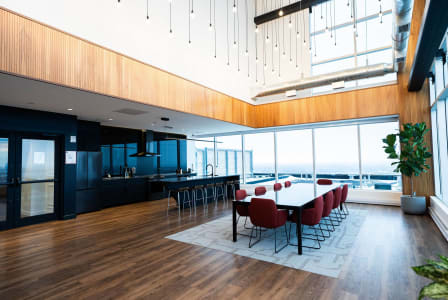 a dining room with a table and chairs in a large room