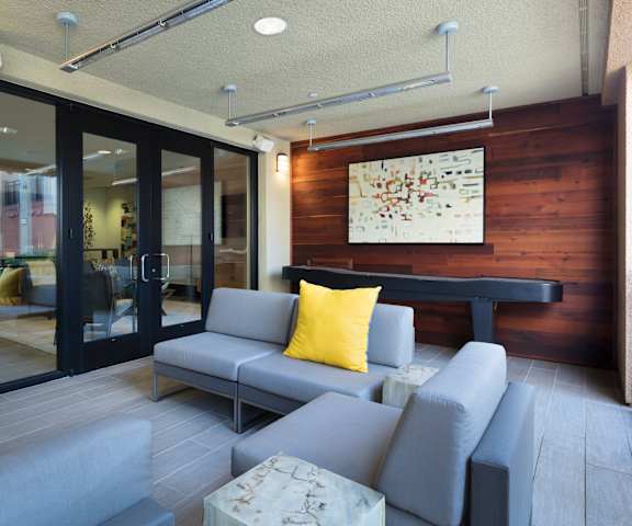 a patio with couches and a ping pong table