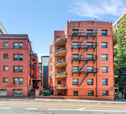 a red building with a fire escape on a city street at Clay & Tiffany, Portland, OR, 97201