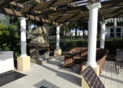 Thumbnail 21 of 28 - Outdoor sitting area with fireplace Allegro Palm Riverview Florida