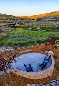 A backyard with a fire pit and a picnic table.