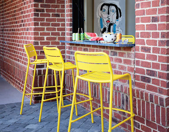 Urban-Style Outdoor Counter with Modern Stools and Refreshments at Allister North Hills Apartments in Raleigh, NC