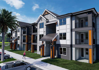 A modern apartment complex with a pedestrian walkway in front.