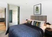 Thumbnail 3 of 7 - a bedroom with a large bed and a mirror