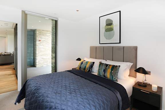 a bedroom with a large bed and a mirror