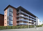 Thumbnail 8 of 9 - a large brick building with a street in front of it