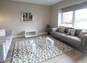 Thumbnail 6 of 9 - a living room with couches and a glass coffee table